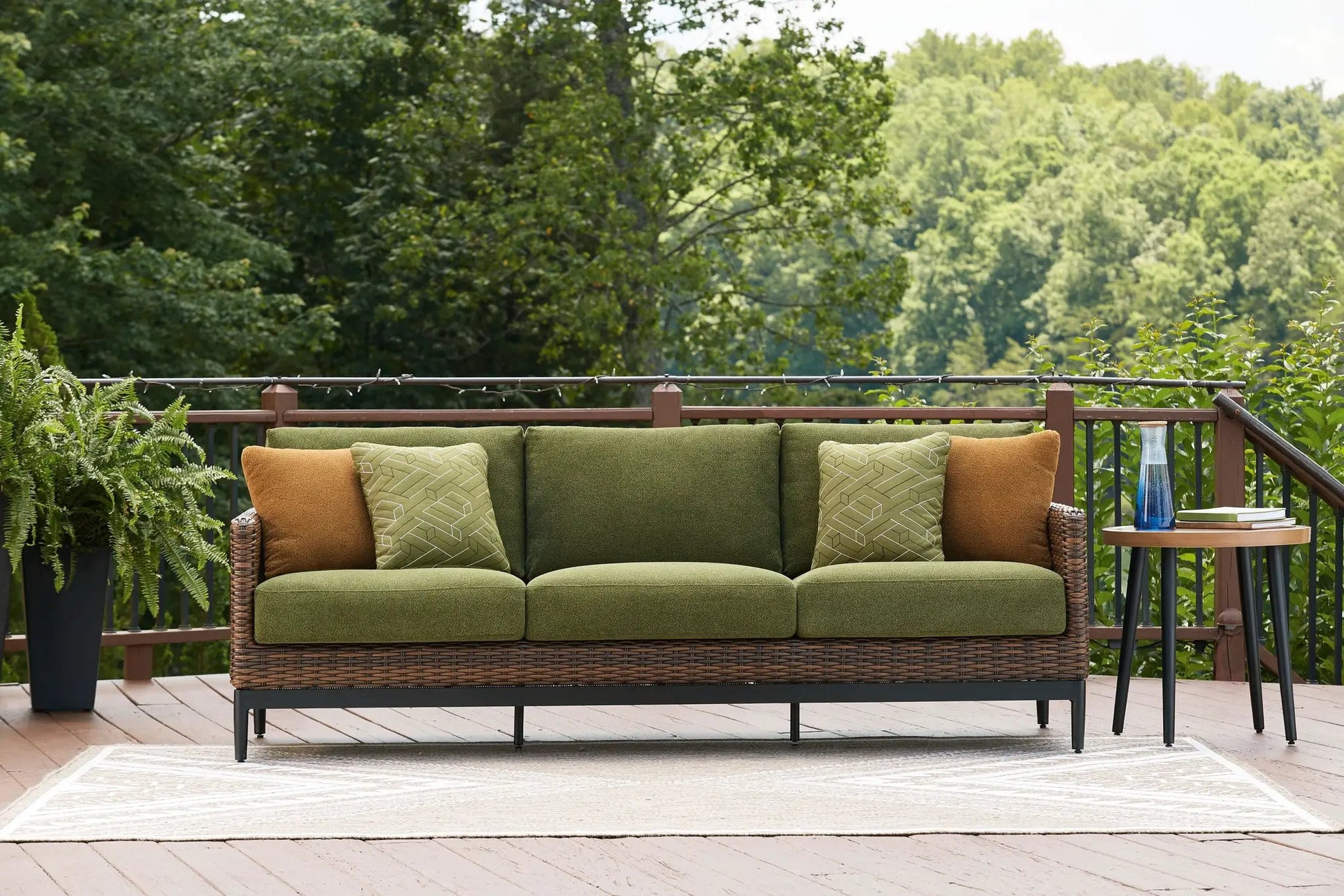 Horizon Hall outdoor sofa with brown/green wicker and olive cushions, green geometric pillows on Tampa Home & Garden Store