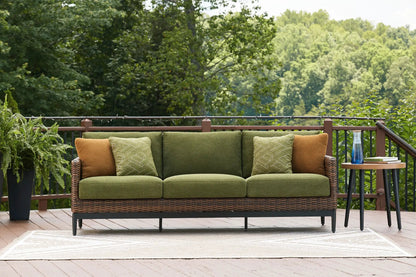Horizon Hall outdoor sofa with brown/green wicker and olive cushions, green geometric pillows on Tampa Home & Garden Store