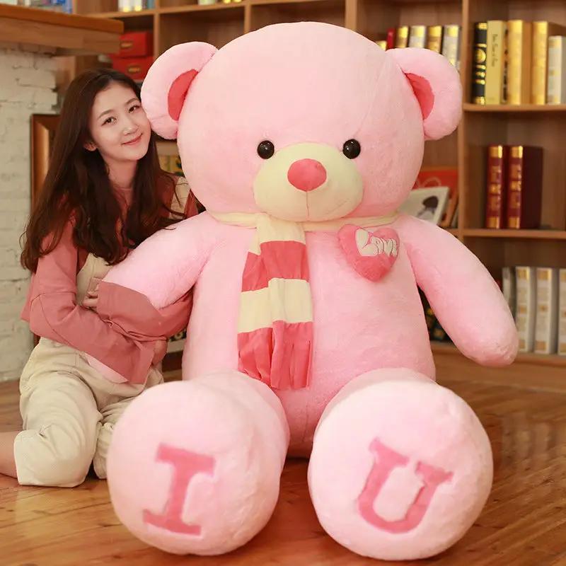 Heart Bear pink plush toy with striped scarf and heart patch, feet show I and U on Tampa Home & Garden Store