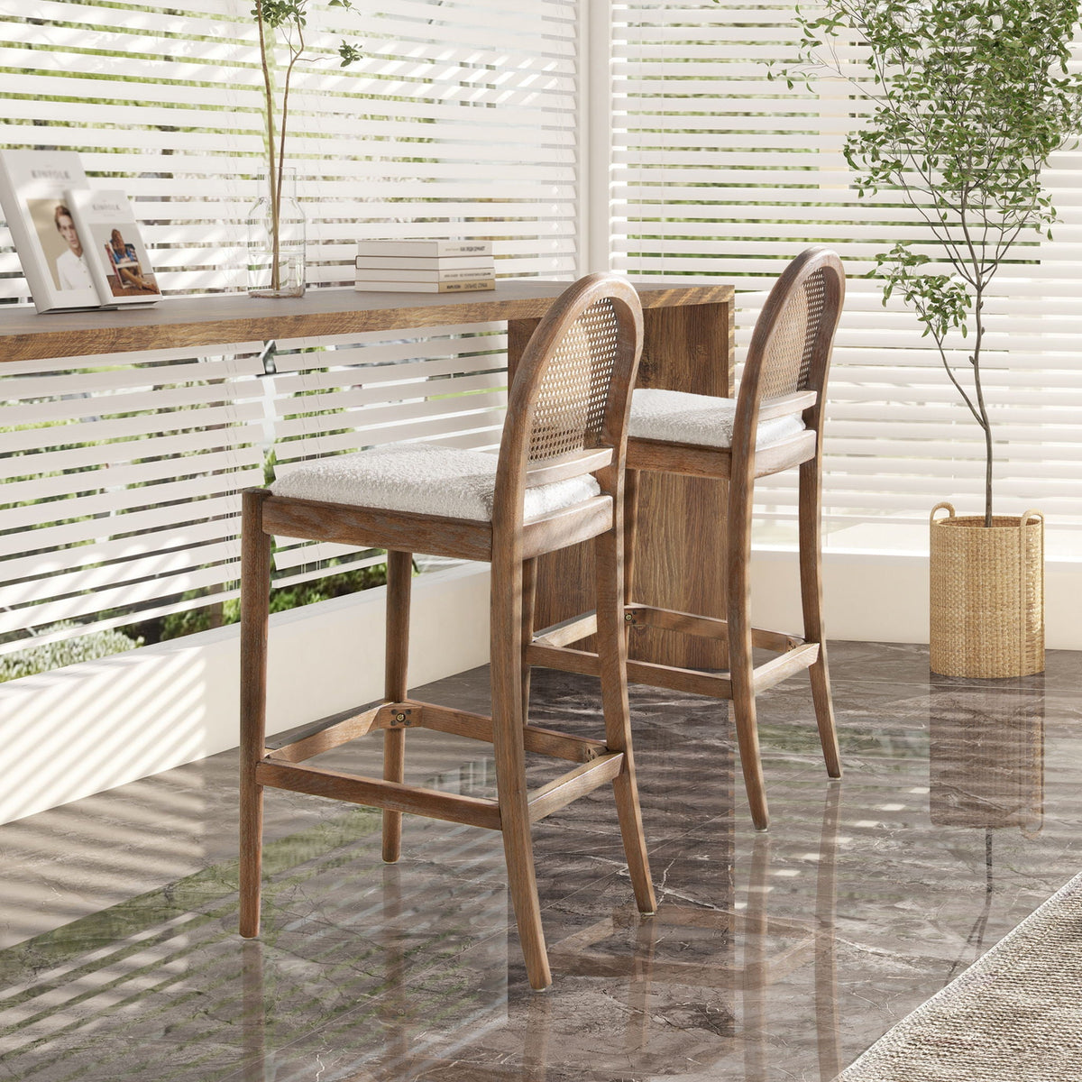 Three curved-back cane bar stools with natural cane weaving and padded white cushions on Tampa Home & Garden Store