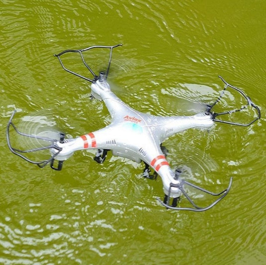 Sell My Stuff X52 Drone toy quadcopter, white with red stripes floating on green water on Tampa Home & Garden Store