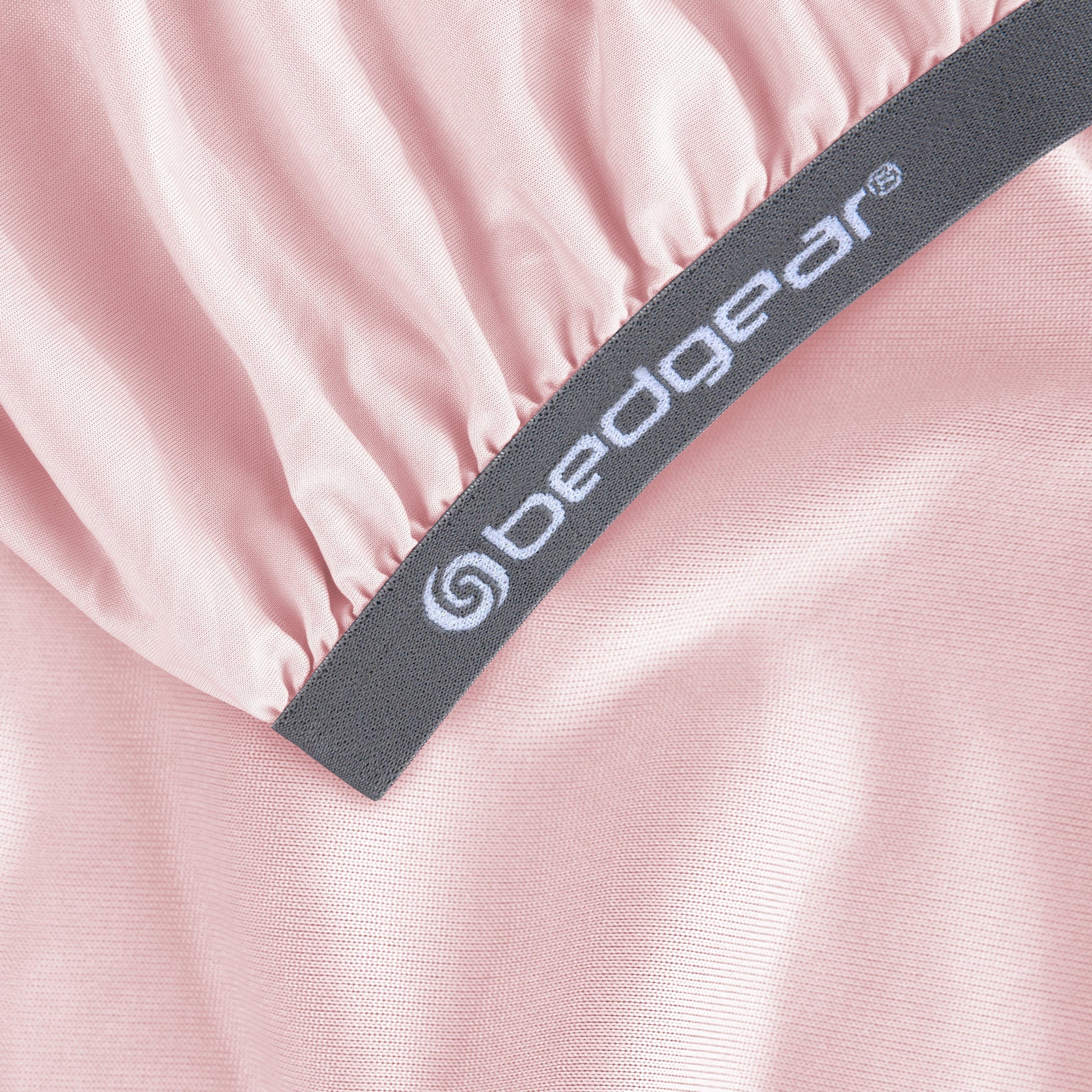 BedGear Hyper-Linen crib sheet in light pink with a gray elastic band and white branding on Tampa Home & Garden Store