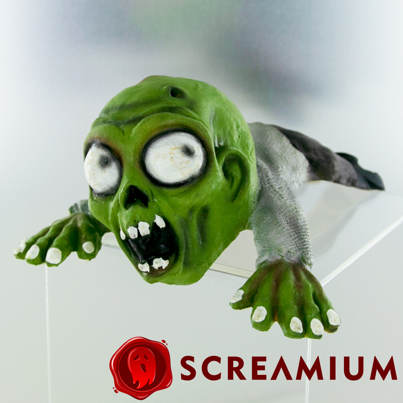 Shoulder Buddy Zombie by SCREAMIUM, green head with bulging white eyes and exposed teeth on Tampa Home & Garden Store