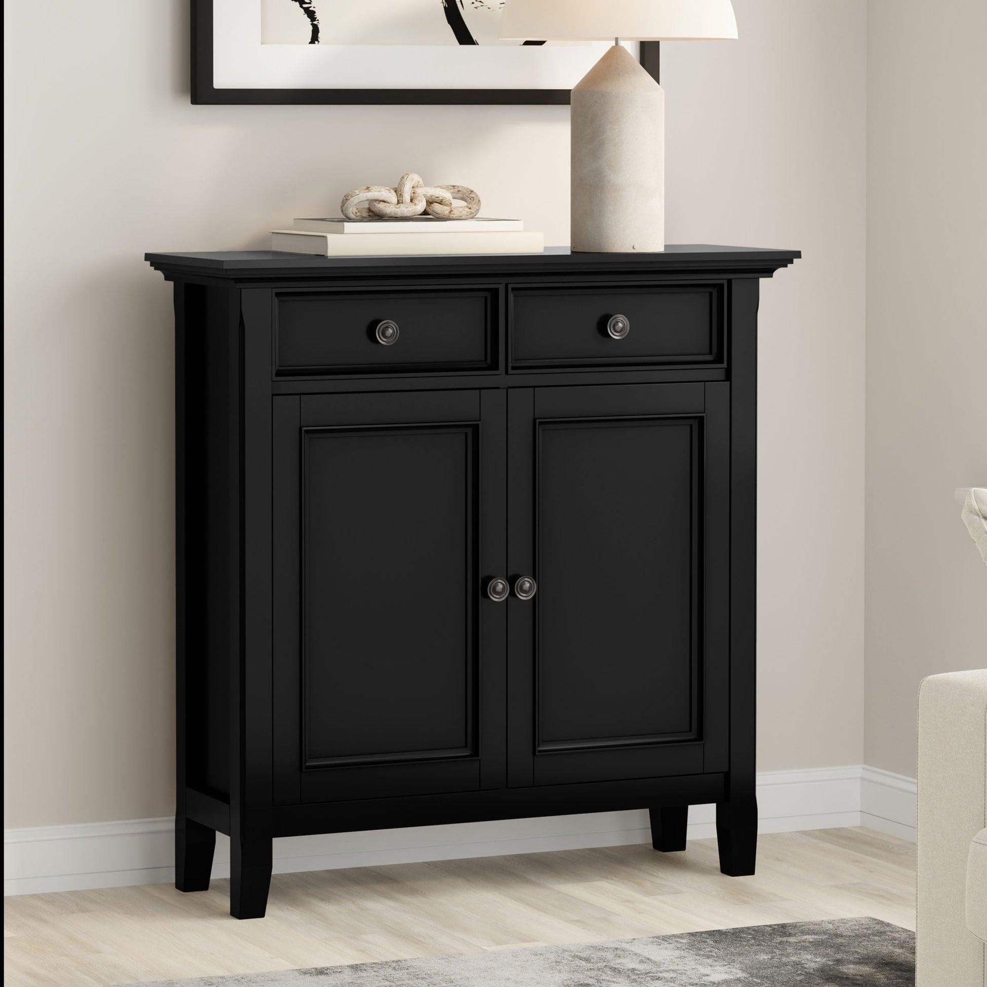 Amherst storage cabinet in black with paneled doors and top drawers; lamp and books on top on Tampa Home & Garden Store