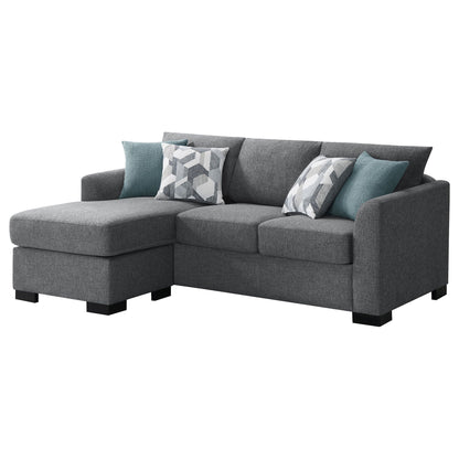 Pacheco sleeper sectional chaise sofa in dark grey fabric with teal geometric pillows on Tampa Home & Garden Store