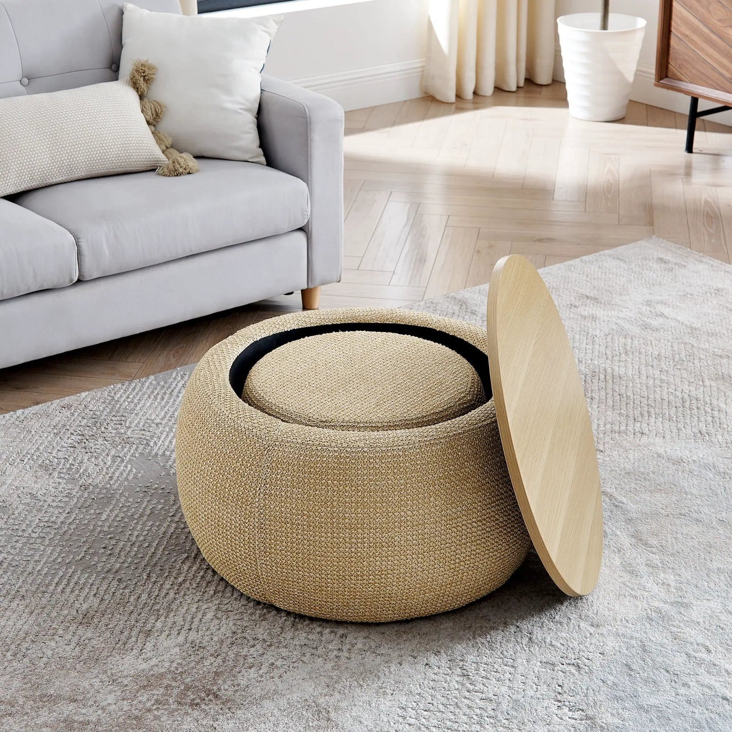 Round storage ottoman in natural woven rattan with 2-in-1 end table function beside a sofa on Tampa Home & Garden Store