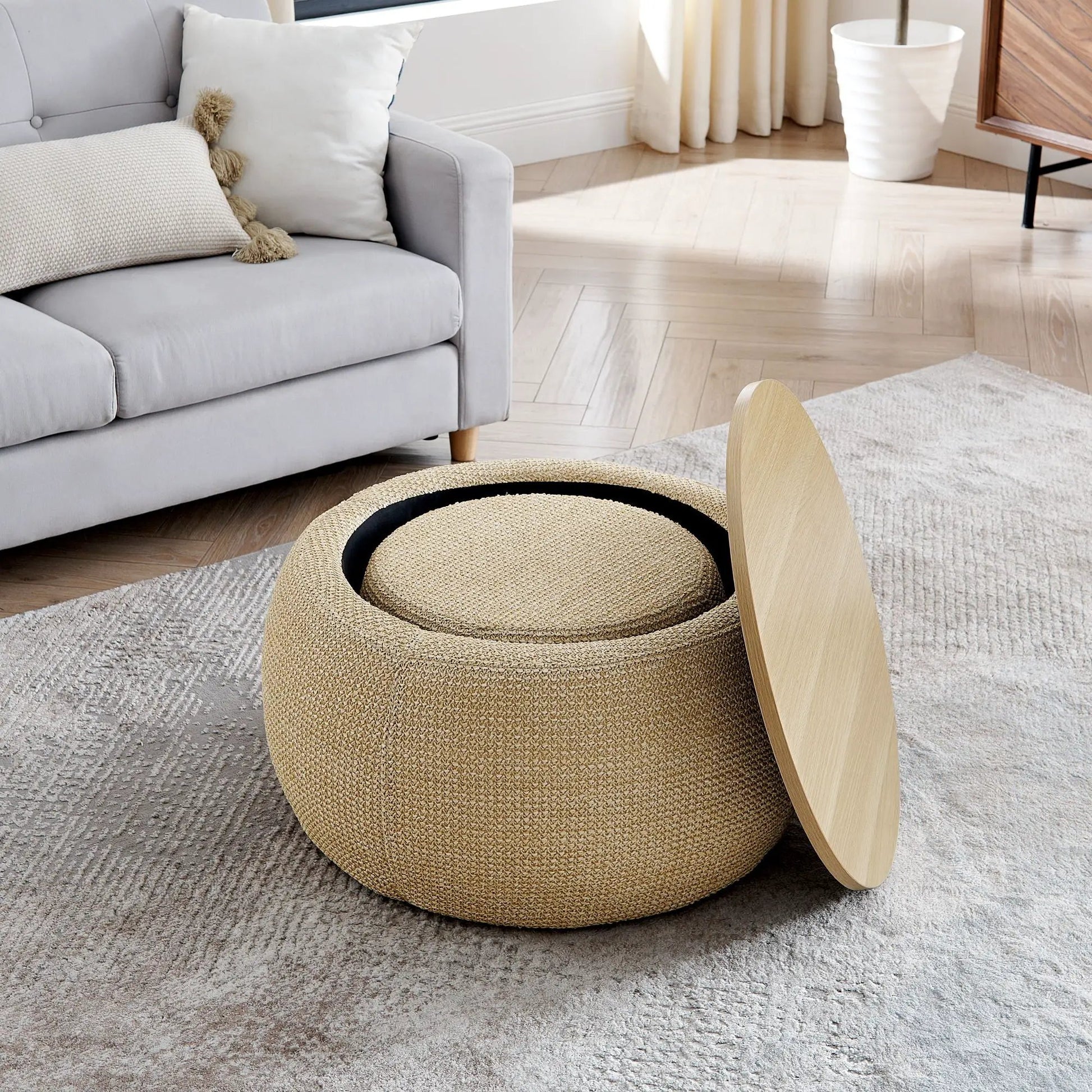 Round storage ottoman in natural woven rattan with 2-in-1 end table function beside a sofa on Tampa Home & Garden Store