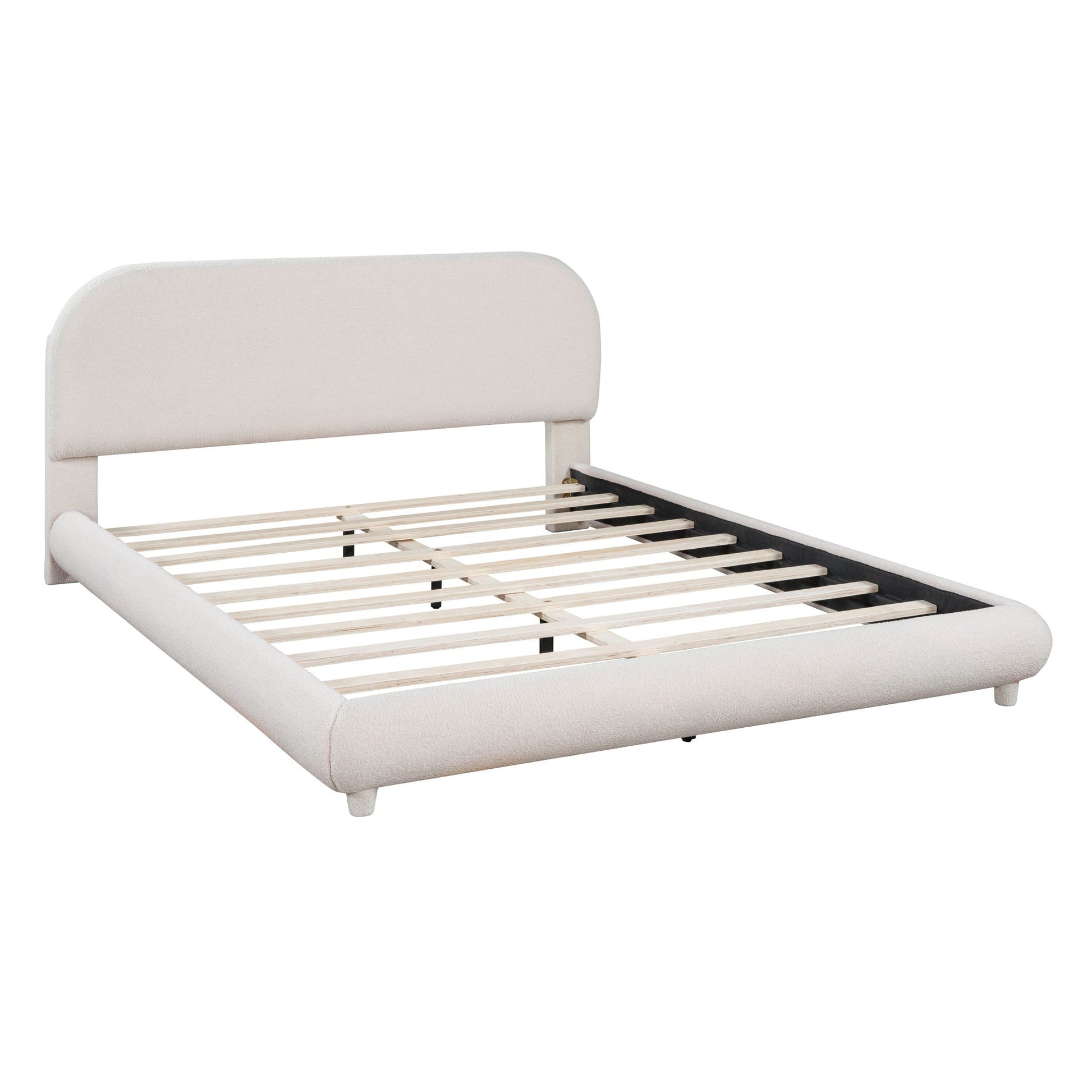 Upholstered platform bed with thick curved headboard in light beige fabric, slatted base on Tampa Home & Garden Store