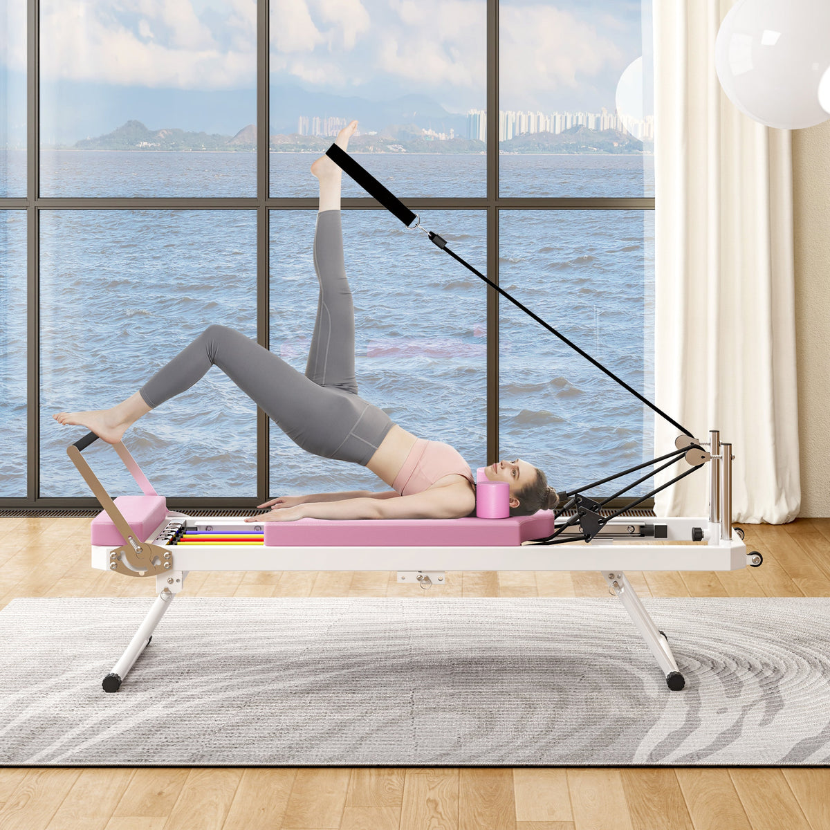 Foldable Pilates Core Bed by HouseOfZazla with mat; woman in gray leggings performs leg raise on Tampa Home & Garden Store