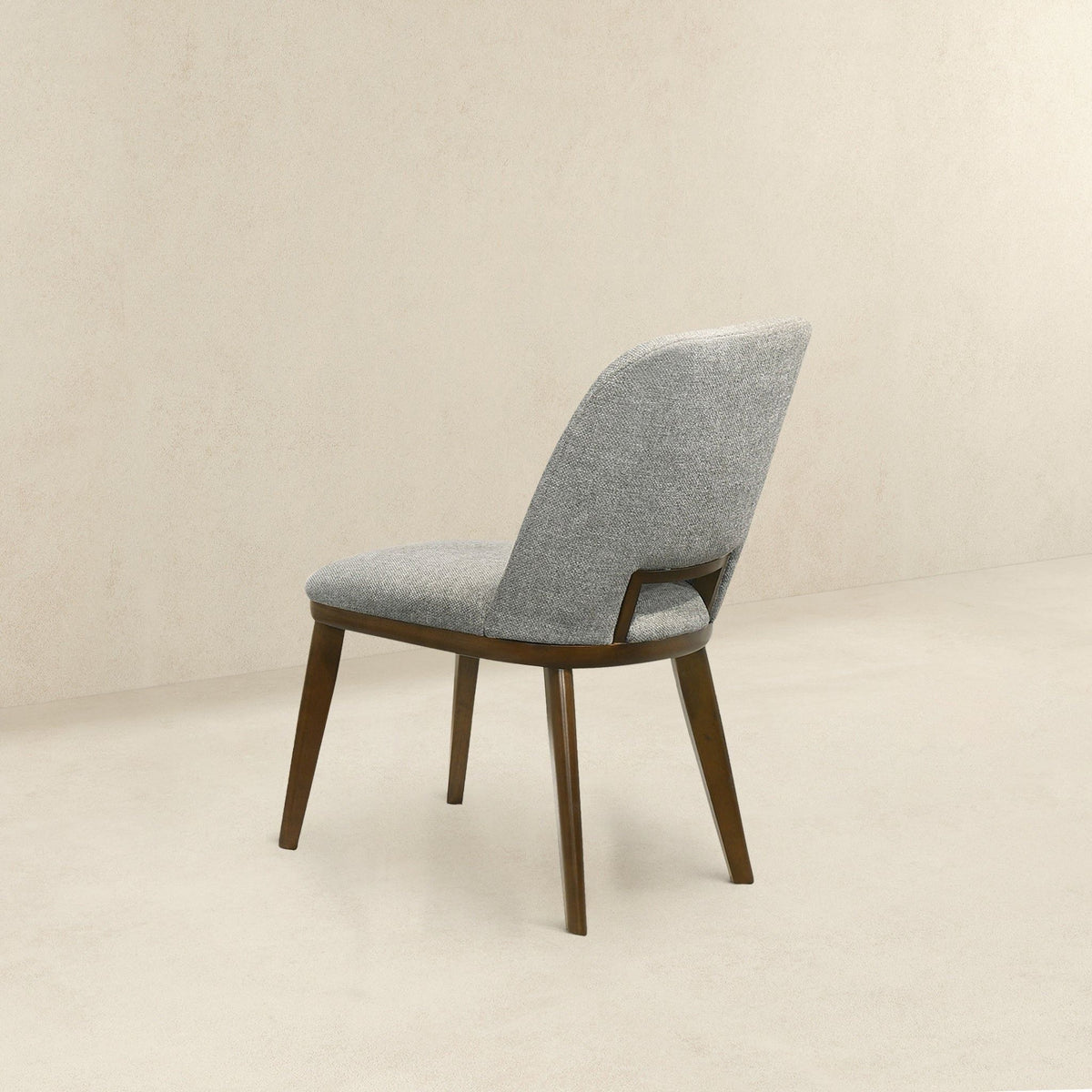Modern dining chair with walnut base in gray fabric upholstery on Tampa Home & Garden Store