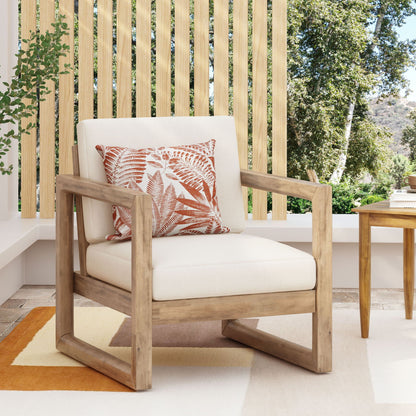 Outdoor Acacia Wood Patio Club Chair by HouseOfZazla with beige cushion and orange fern-pattern pillow on Tampa Home & Garden Store