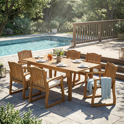 7-Piece Acacia Wood Outdoor Dining Set with Cream Cushions on a poolside deck with string lights on Tampa Home & Garden Store