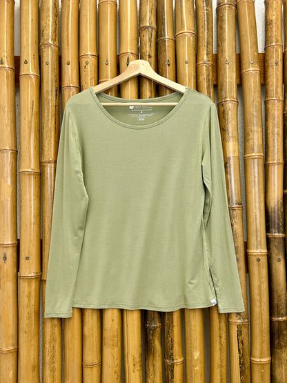 Women's Bamboo Long Sleeve T-Shirt Spun Bamboo in olive green fabric on a hanger amid bamboo on Tampa Home & Garden Store