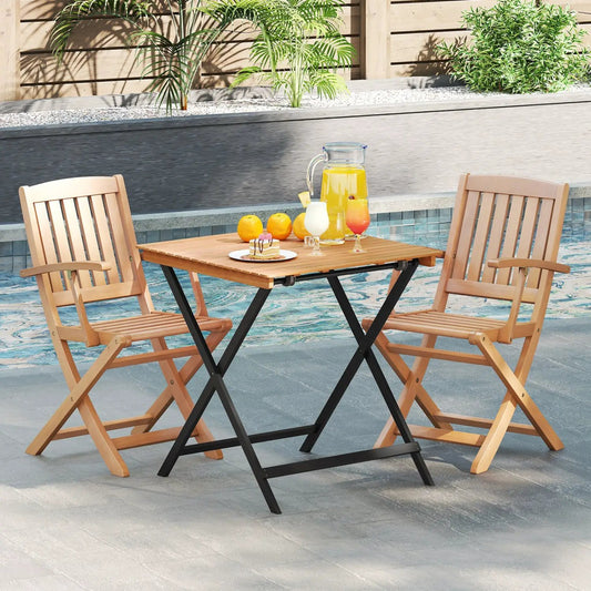 28 Inch patio folding table with slatted wood top and black X-frame legs poolside with two chairs on Tampa Home & Garden Store