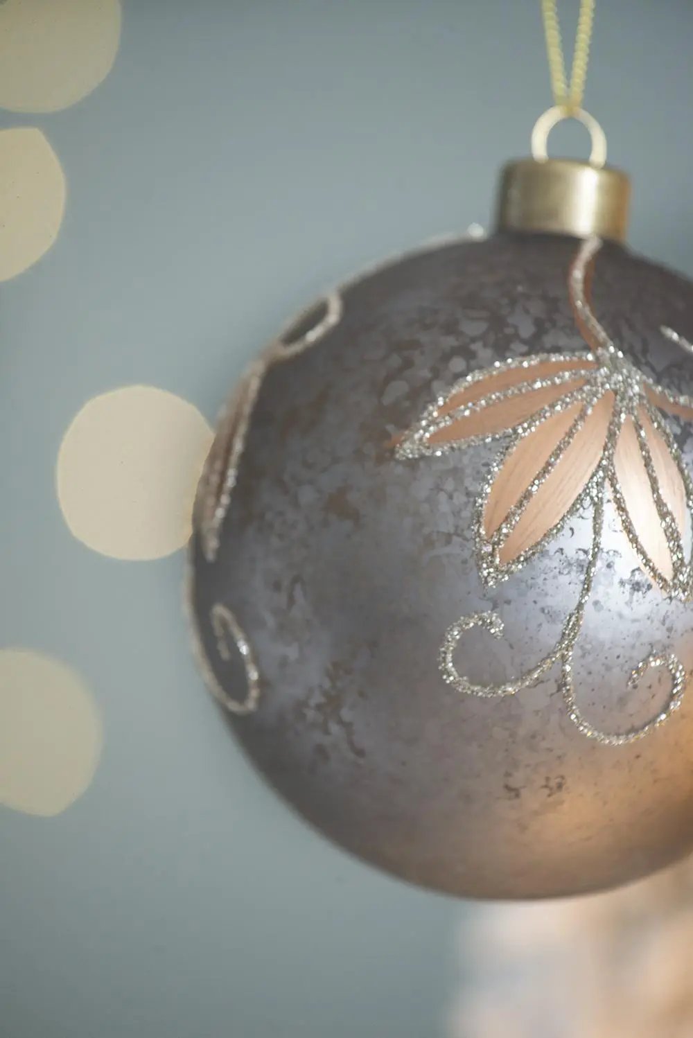 Christmas ball ornament with metallic gray finish and pink glitter floral motif hanging loop on Tampa Home & Garden Store