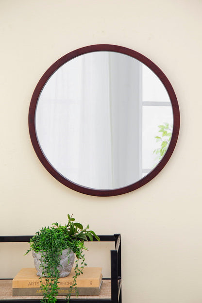 Circle Wall Mirror with Wooden Frame in dark wood; plant in gray pot sits on books below on Tampa Home & Garden Store