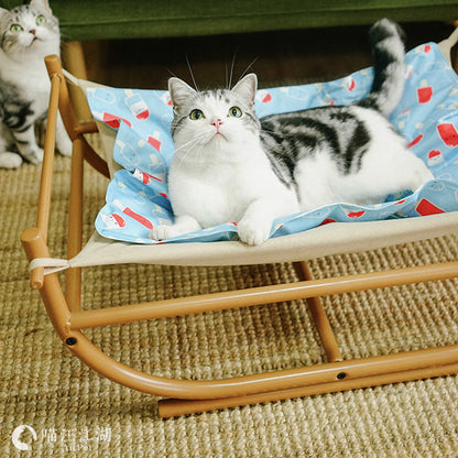 Iron Cat Hammock Pet Sofa Bed with beige frame and blue printed liner, cat lounging on it on Tampa Home & Garden Store