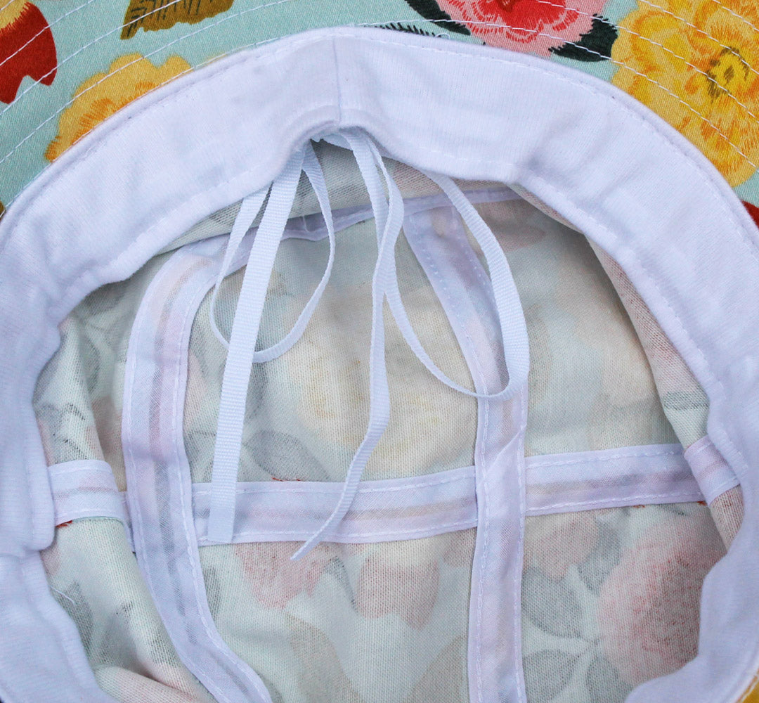 Cotton bucket sun hat by Womanswork with white interior ties and Heirloom Garden floral print on Tampa Home & Garden Store