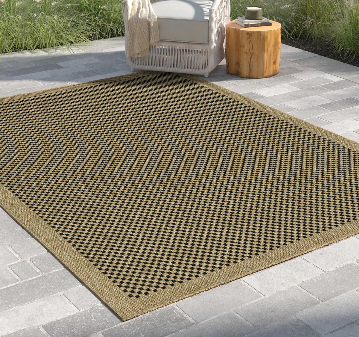 Black and Natural Jute Indoor Outdoor Area Rug by HouseOfZazla on a stone patio on Tampa Home & Garden Store