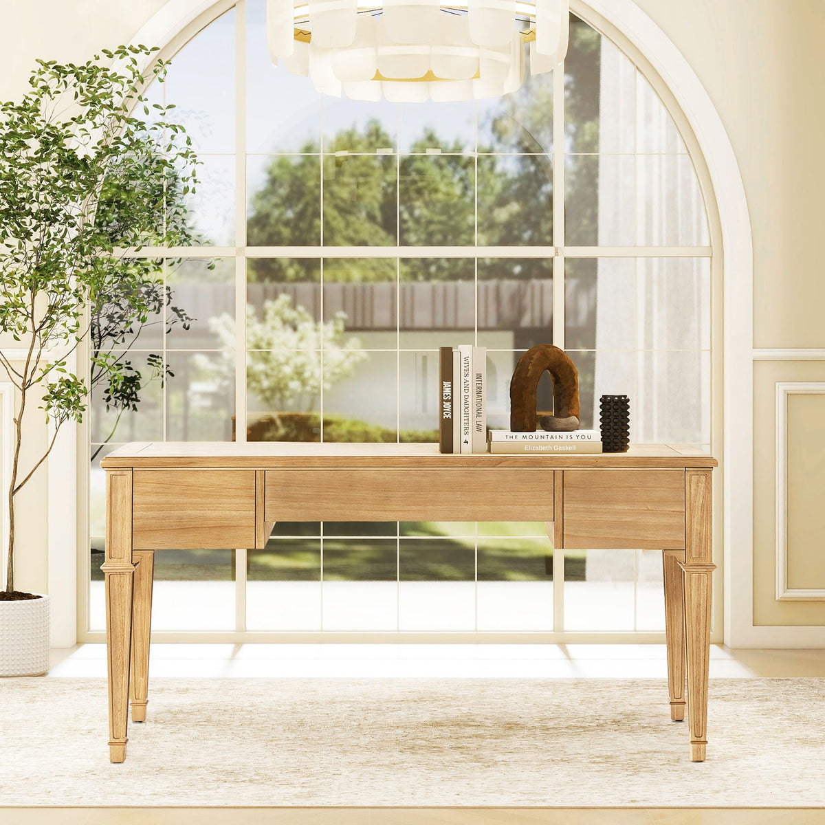 Dauphin 3 Drawer Executive Desk in light brown wood with soft-close drawers beside a large arched window on Tampa Home & Garden Store