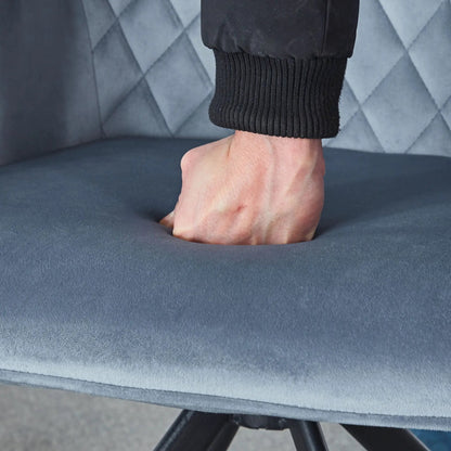 Modern desk chair close-up with ankle in black ribbed cuff on blue upholstery and metal leg on Tampa Home & Garden Store