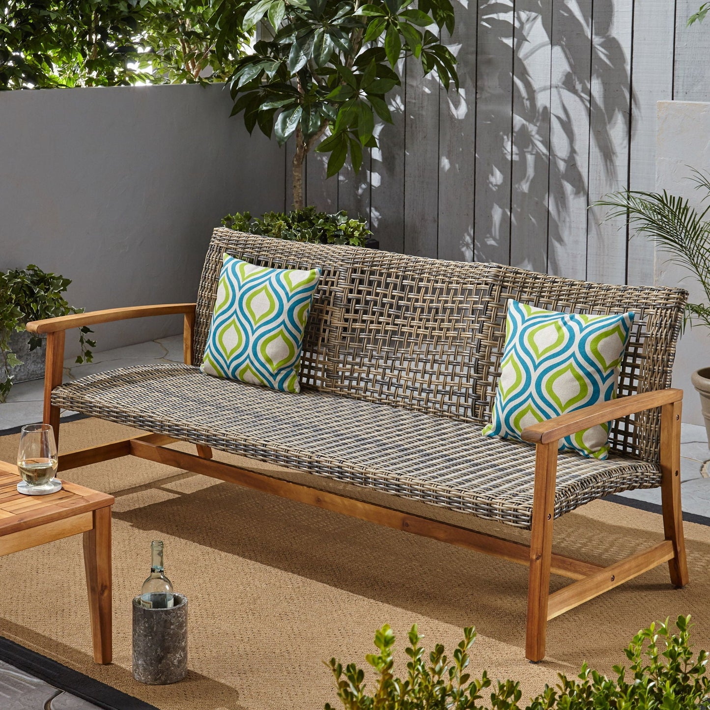 Outdoor 3 Seater sofa with gray rattan cover on wood frame by HouseOfZazla, patterned cushions on Tampa Home & Garden Store