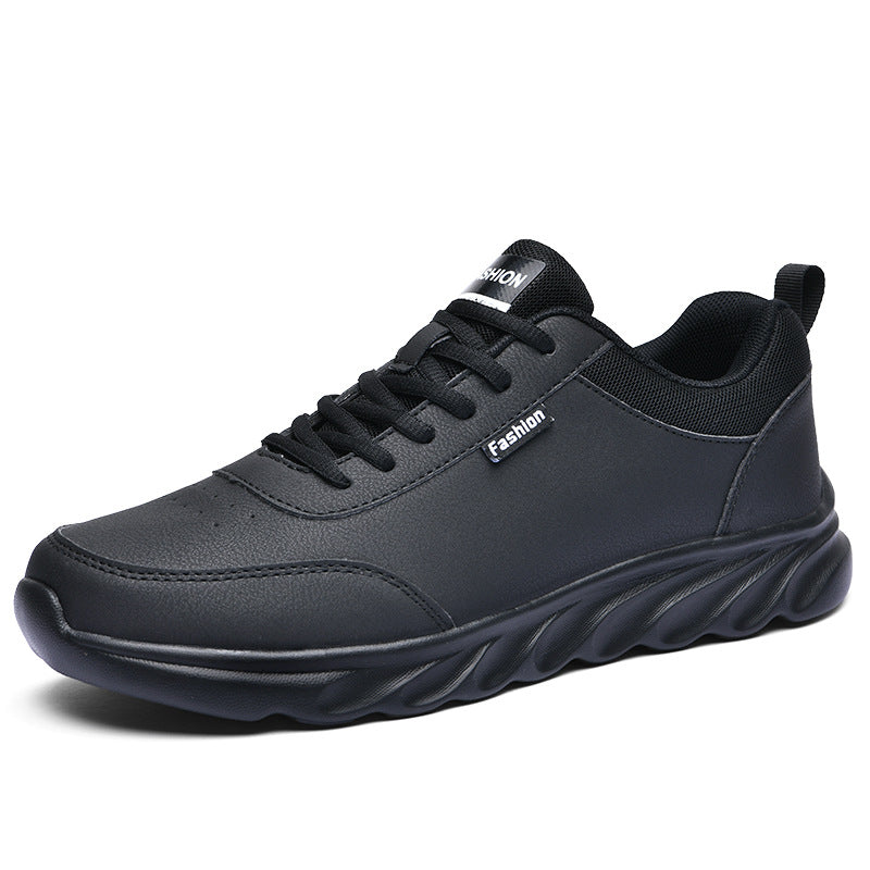 Men's black athletic sneakers with lace-up front and textured wavy outsole on Tampa Home & Garden Store