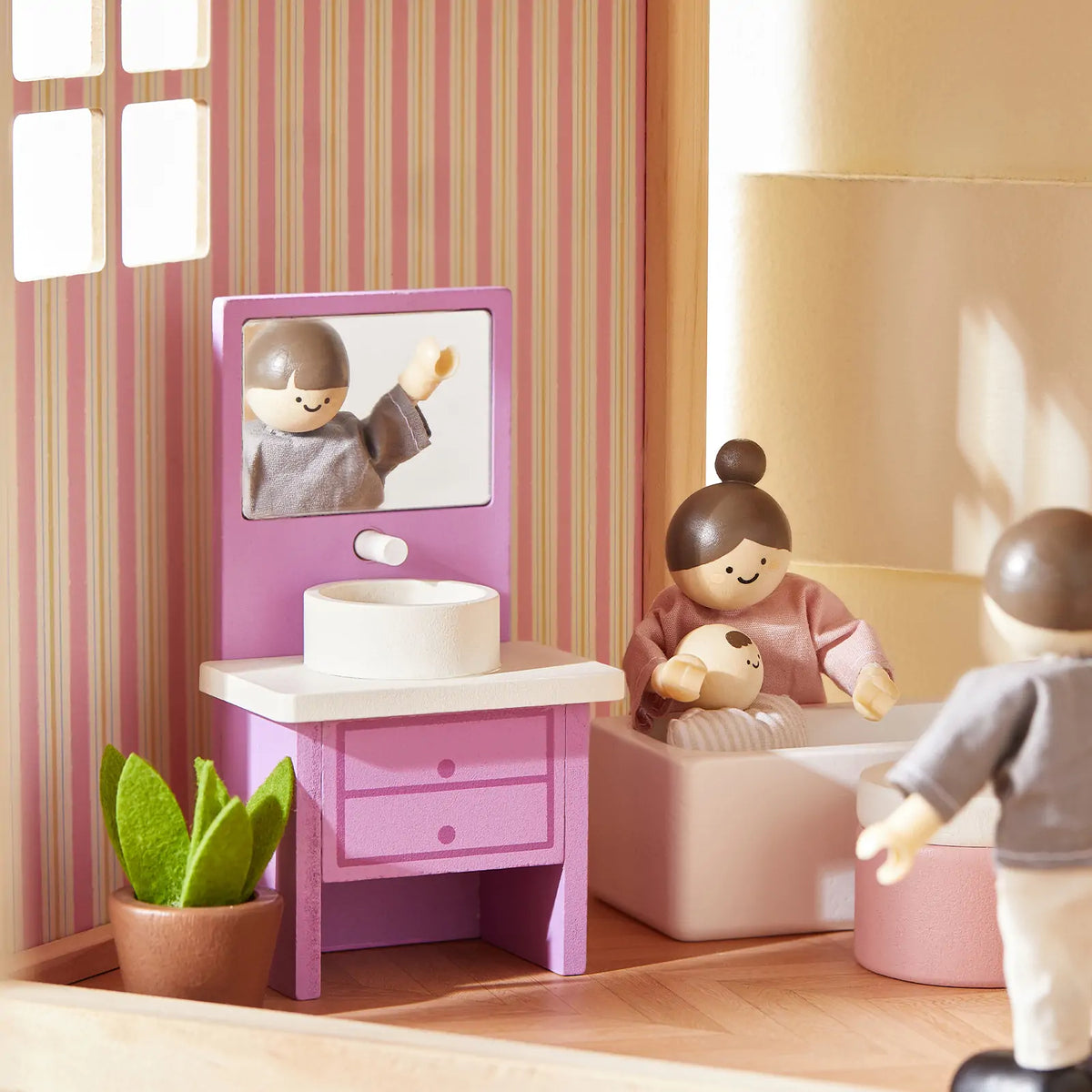 Tiny Land Sweetwood Unicorn Dollhouse with pink kitchen and several wooden dolls on Tampa Home & Garden Store