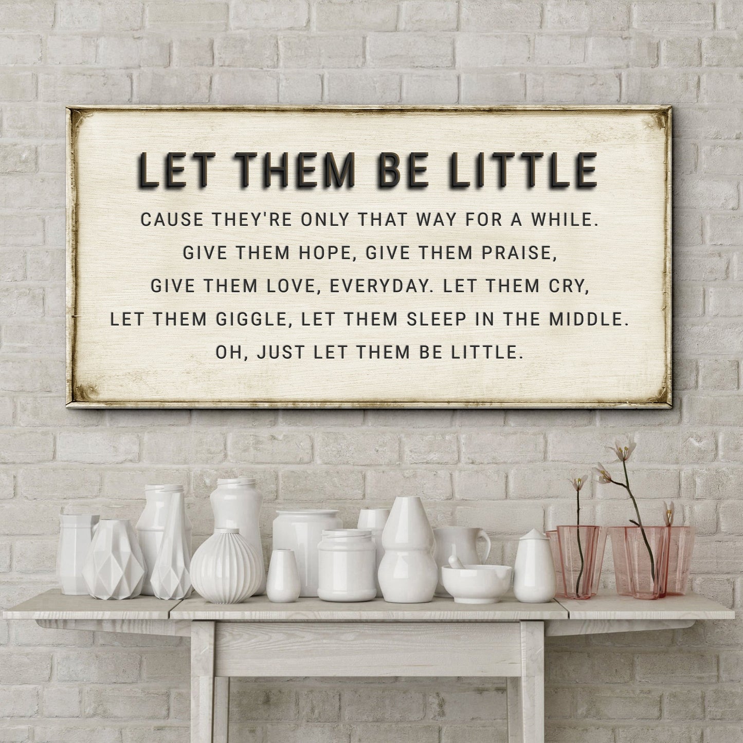Let Them Be Little canvas sign by Tailored Canvases; cream canvas, bold text, on rustic table on Tampa Home & Garden Store