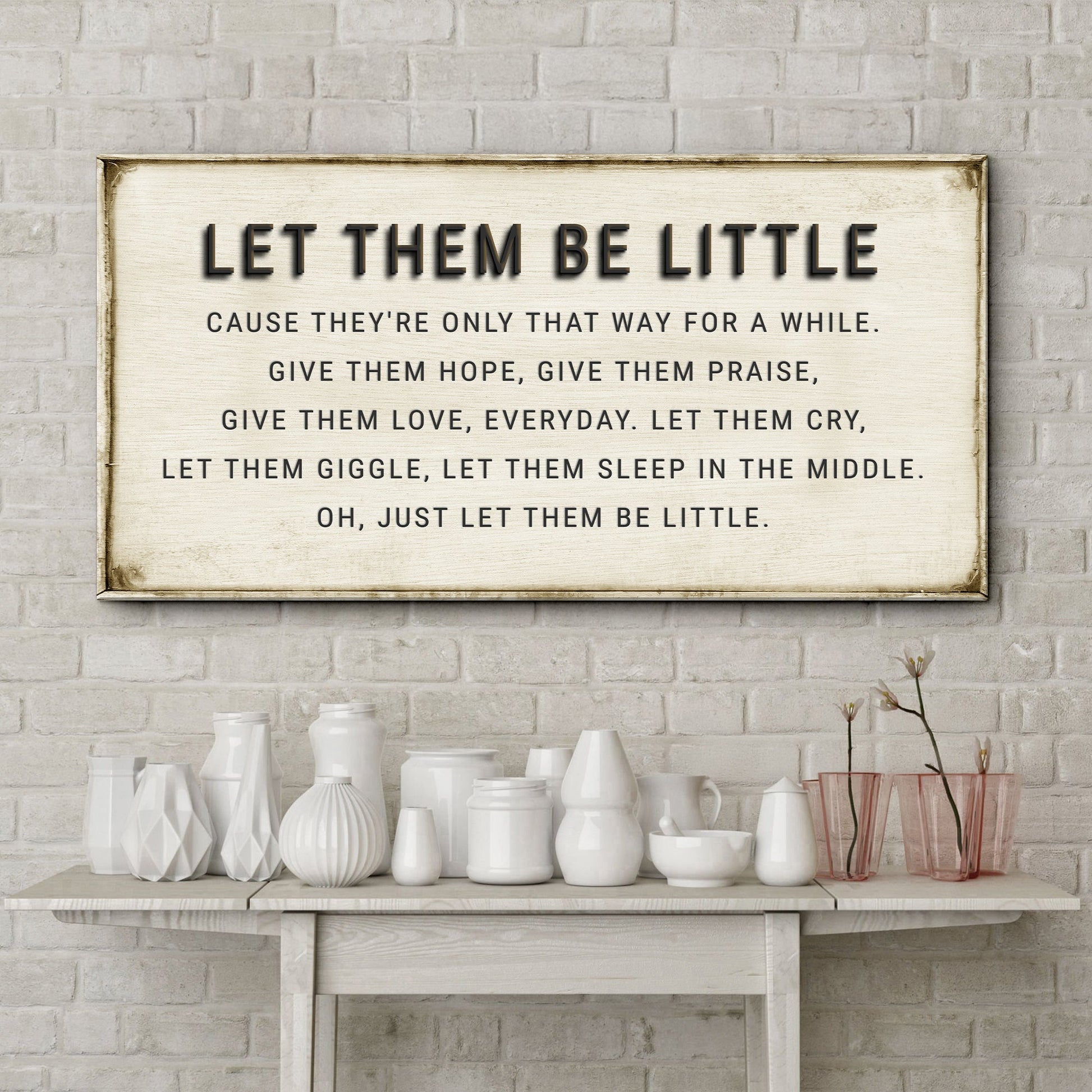 Let Them Be Little canvas sign by Tailored Canvases; cream canvas, bold text, on rustic table on Tampa Home & Garden Store