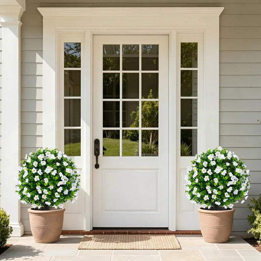 Artificial eucalyptus topiary trees in cement planters, 2-pack flanking a white front door on Tampa Home & Garden Store
