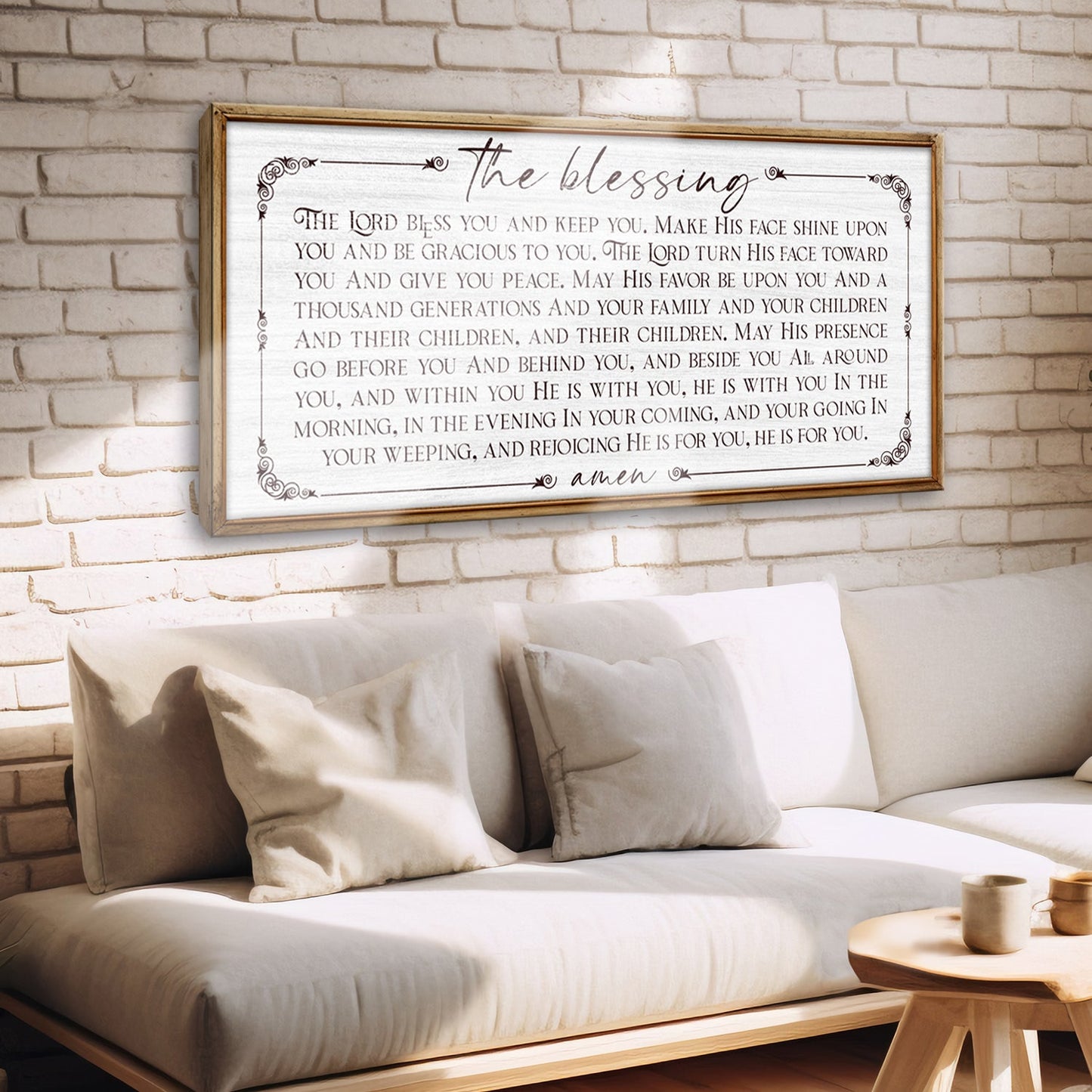 The Blessing Faith Sign canvas with wood frame on brick wall above a beige sofa with cushions on Tampa Home & Garden Store