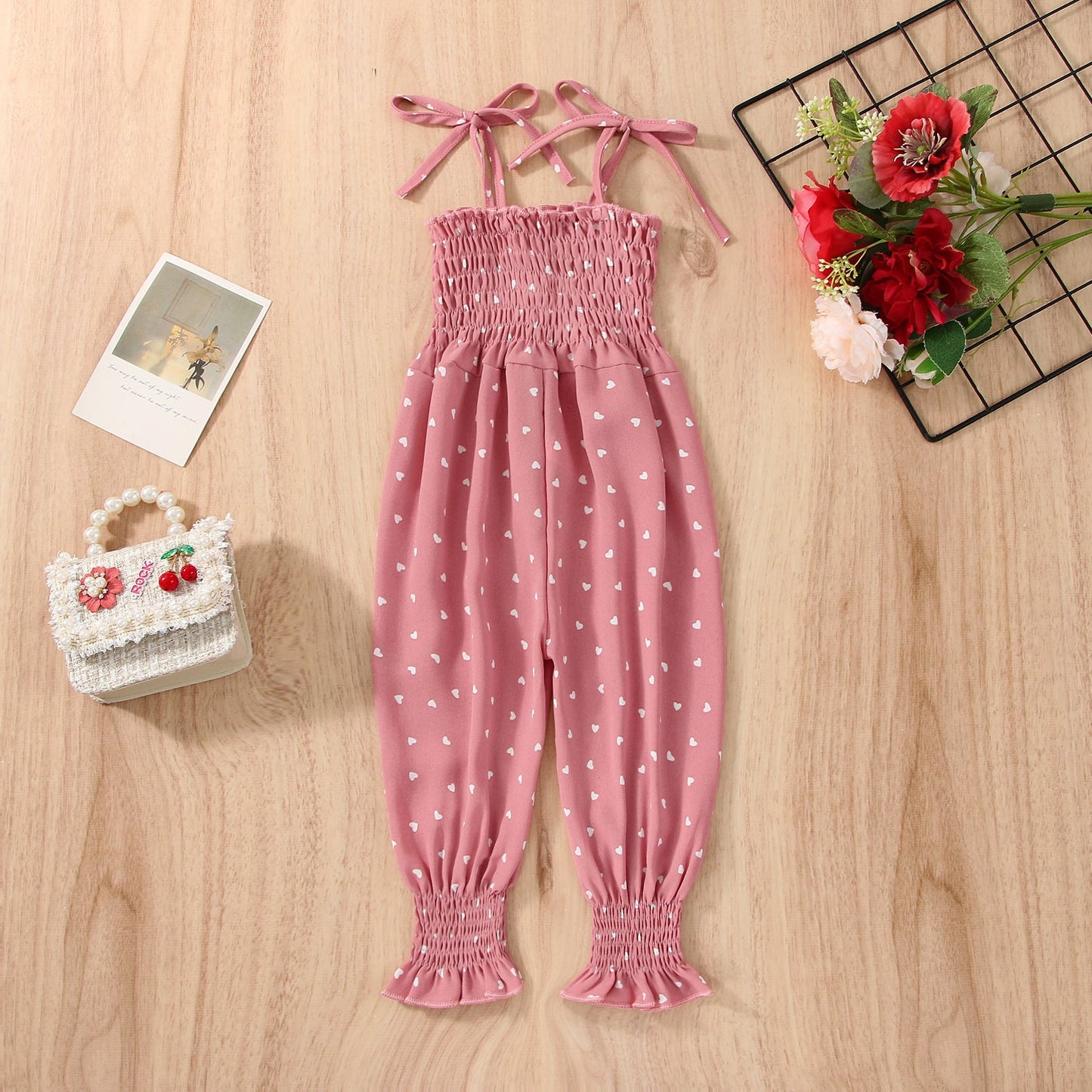 Stevvex pink baby romper with sleeveless straps, white hearts and smocked bodice on Tampa Home & Garden Store