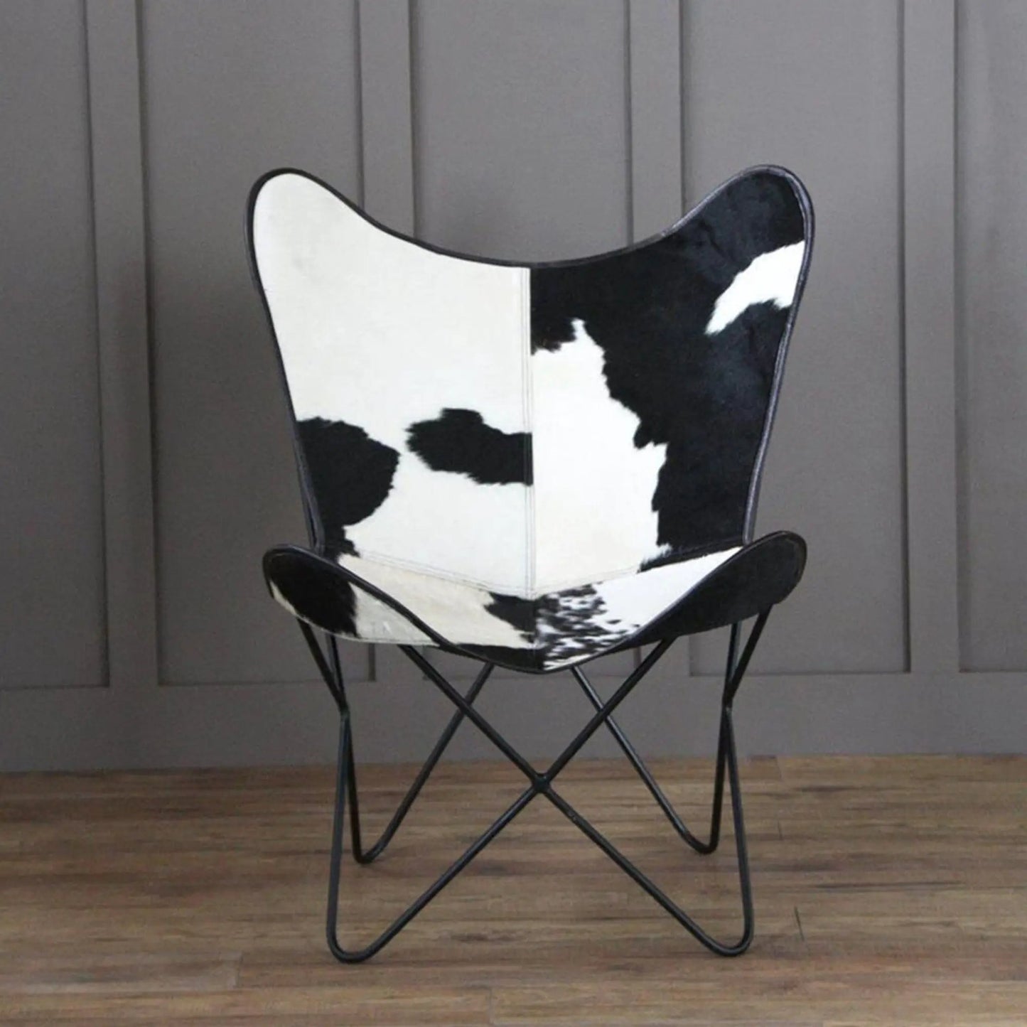 Holsteins Butterfly Chair with cowhide upholstery on a black metal frame on Tampa Home & Garden Store