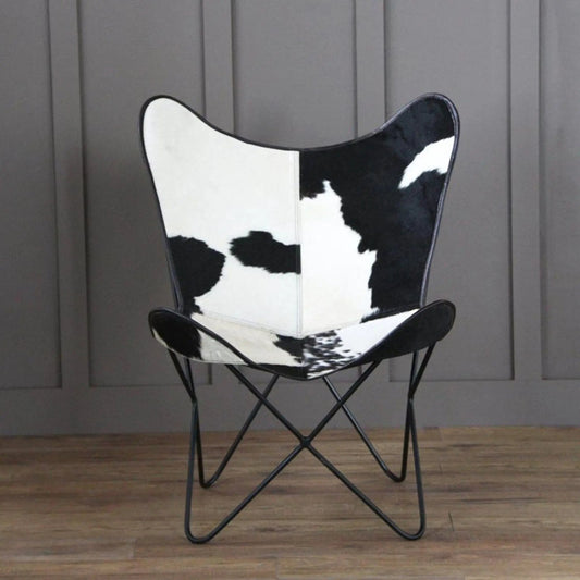 Holsteins Butterfly Chair with cowhide upholstery on a black metal frame on Tampa Home & Garden Store