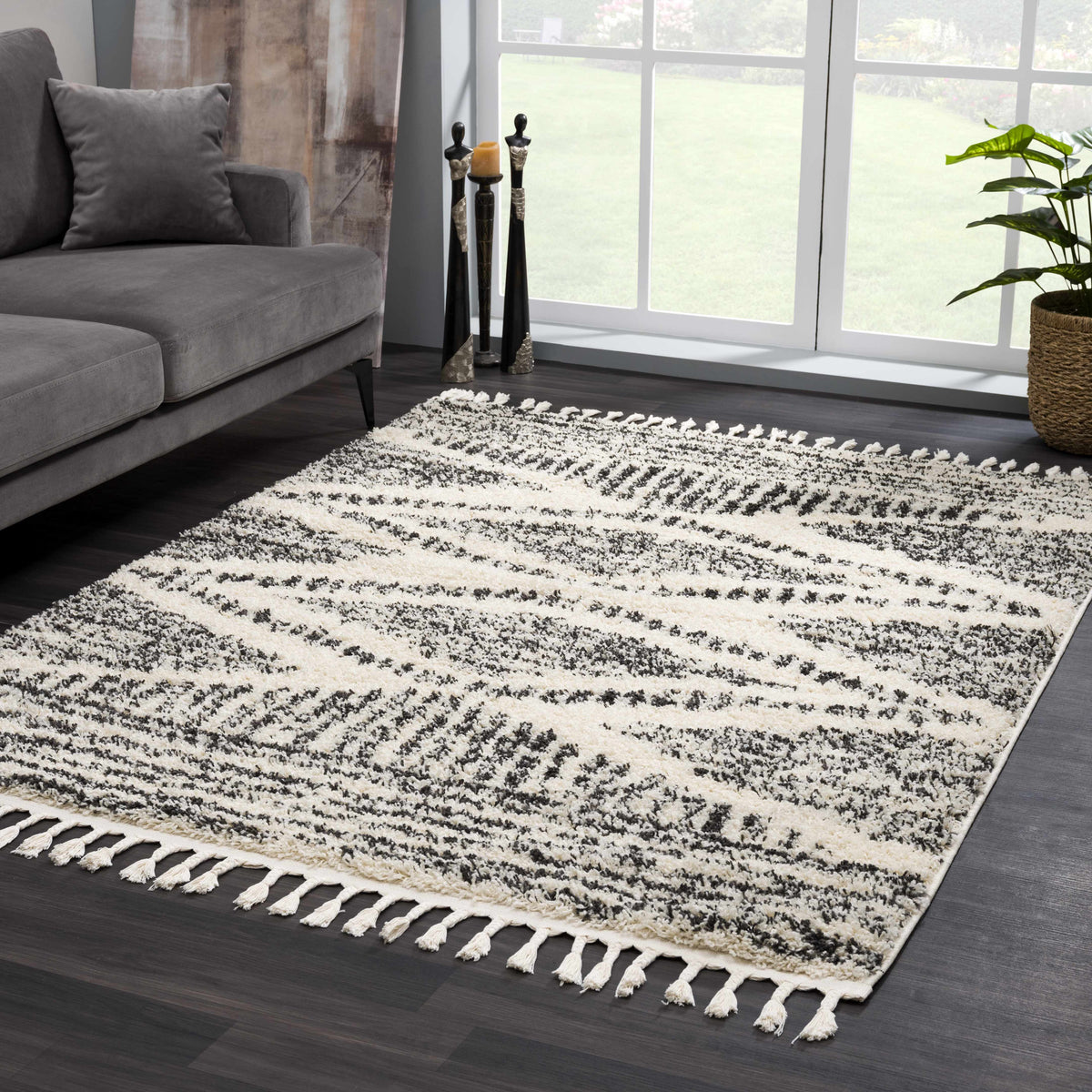 Fishhook Berber Shag Rug in cream with black speckled pattern and tassel fringe in living room on Tampa Home & Garden Store
