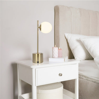 Ethereal modern small table lamp with gold globe shade on white nightstand beside pink candles on Tampa Home & Garden Store