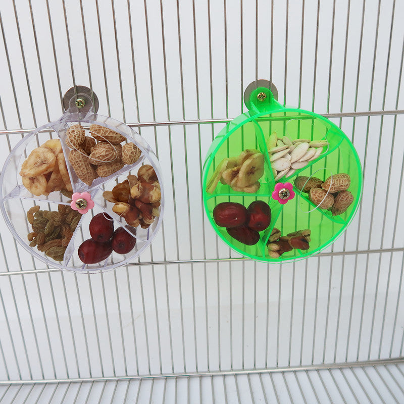 Two circular acrylic foraging wind wheel bird toys in clear and neon green on Tampa Home & Garden Store