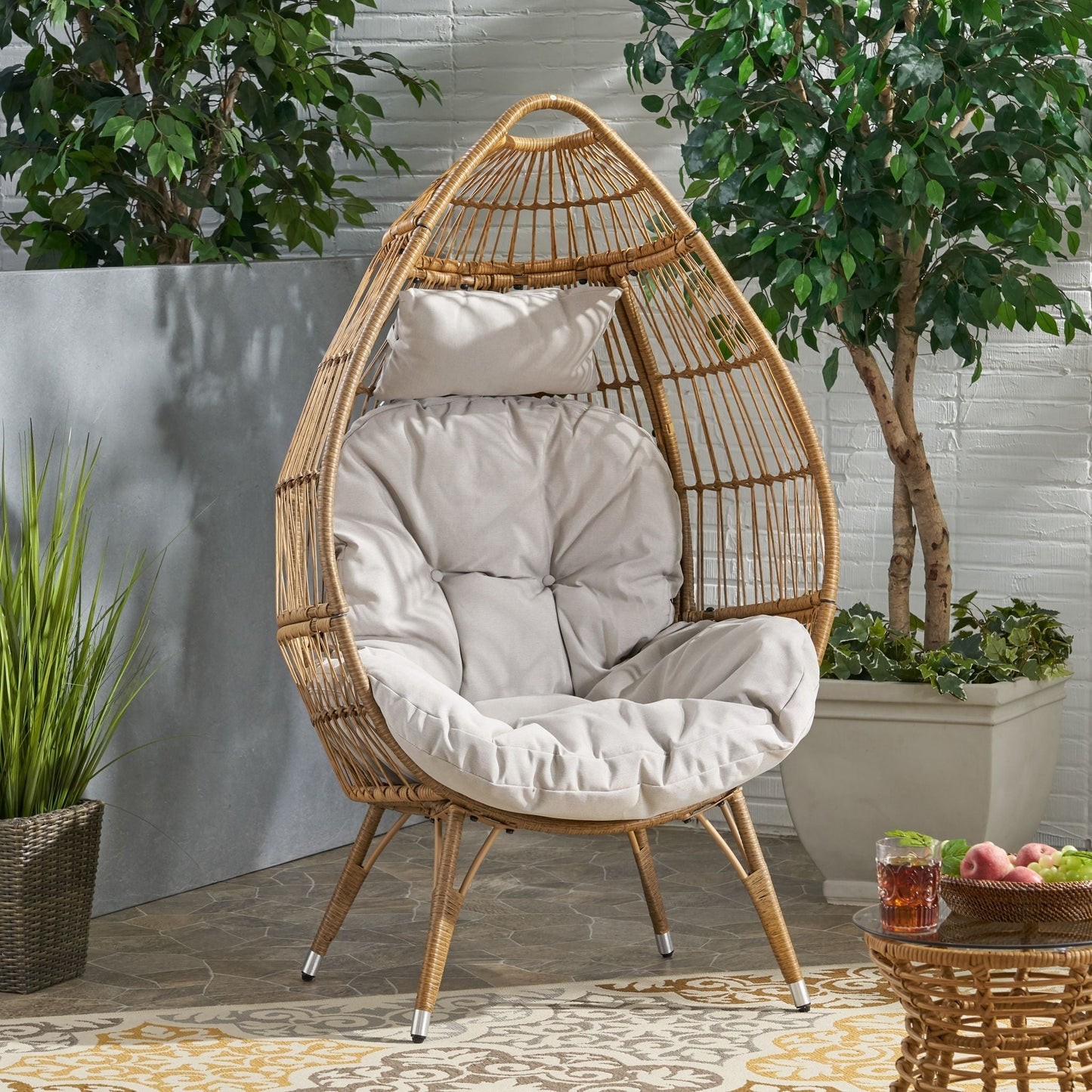 Basket teardrop wicker chair with natural finish and water-resistant cushion on Tampa Home & Garden Store