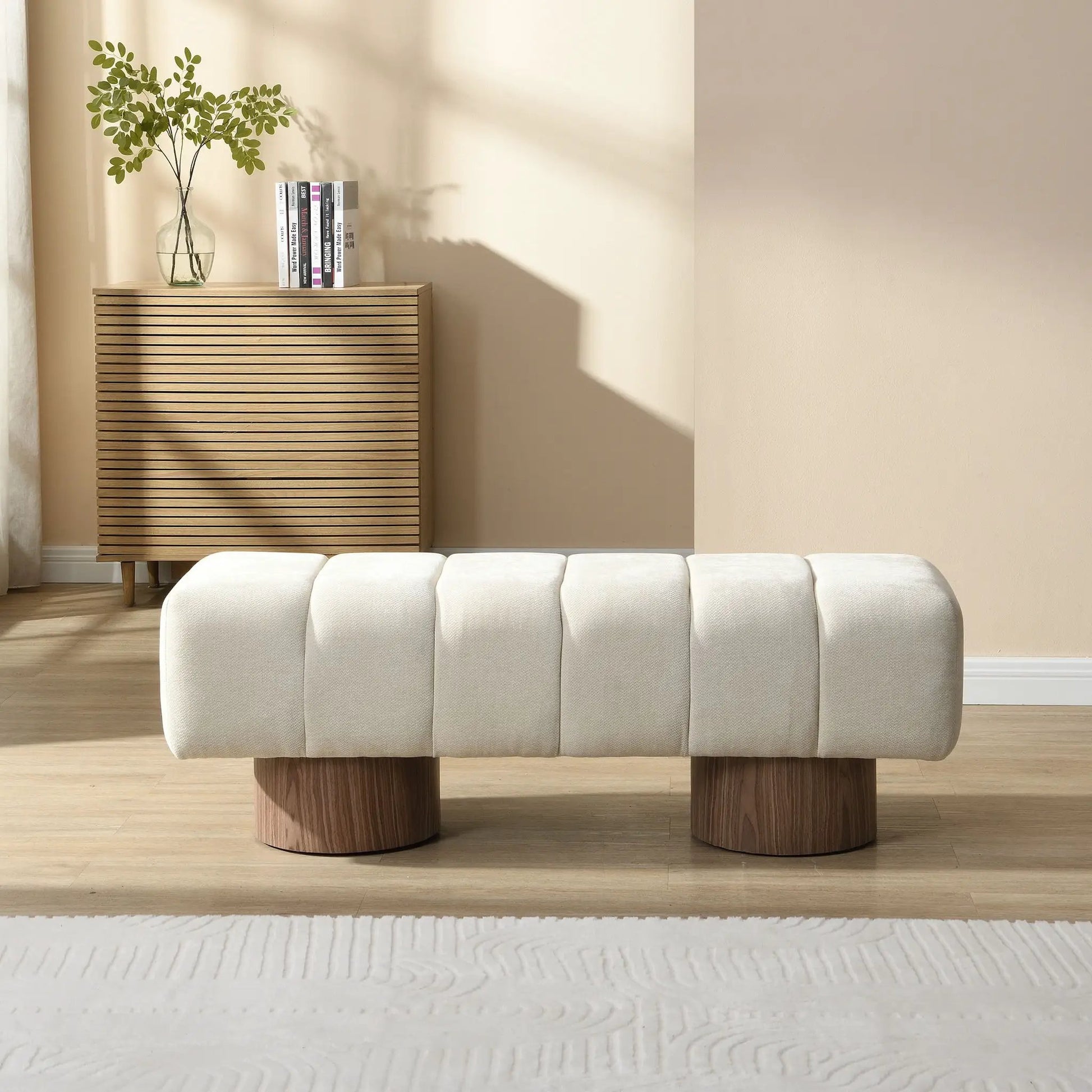 Upholstered dining bench in light beige fabric with three-seat sections on chunky round wood legs on Tampa Home & Garden Store
