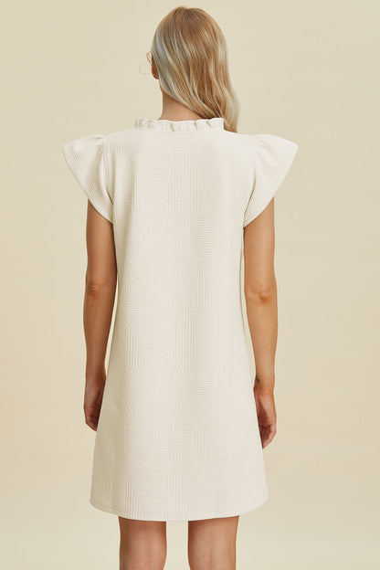 Stevvex ivory textured dress with ruffled cap sleeves, back view, full-size on Tampa Home & Garden Store