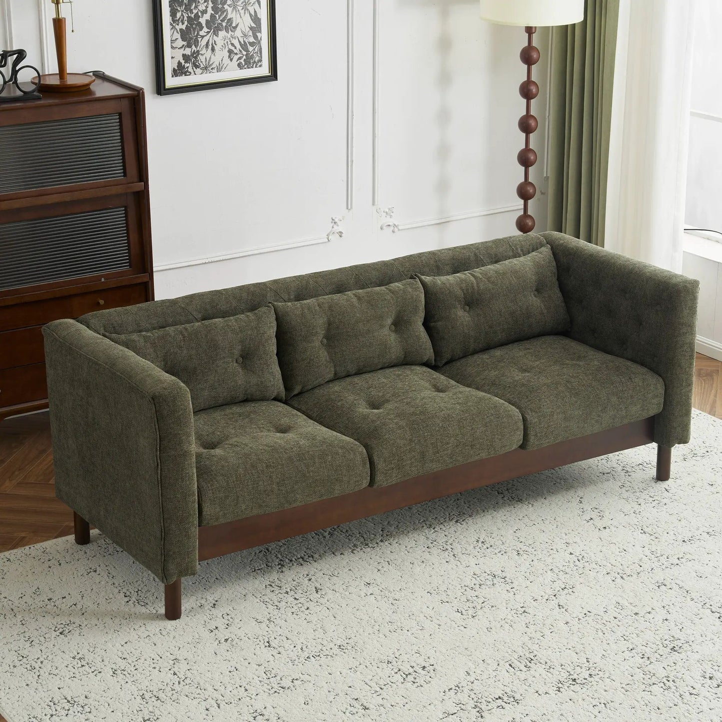 3-seat upholstered sofa in olive-gray fabric with tufted cushions and dark wood base on Tampa Home & Garden Store
