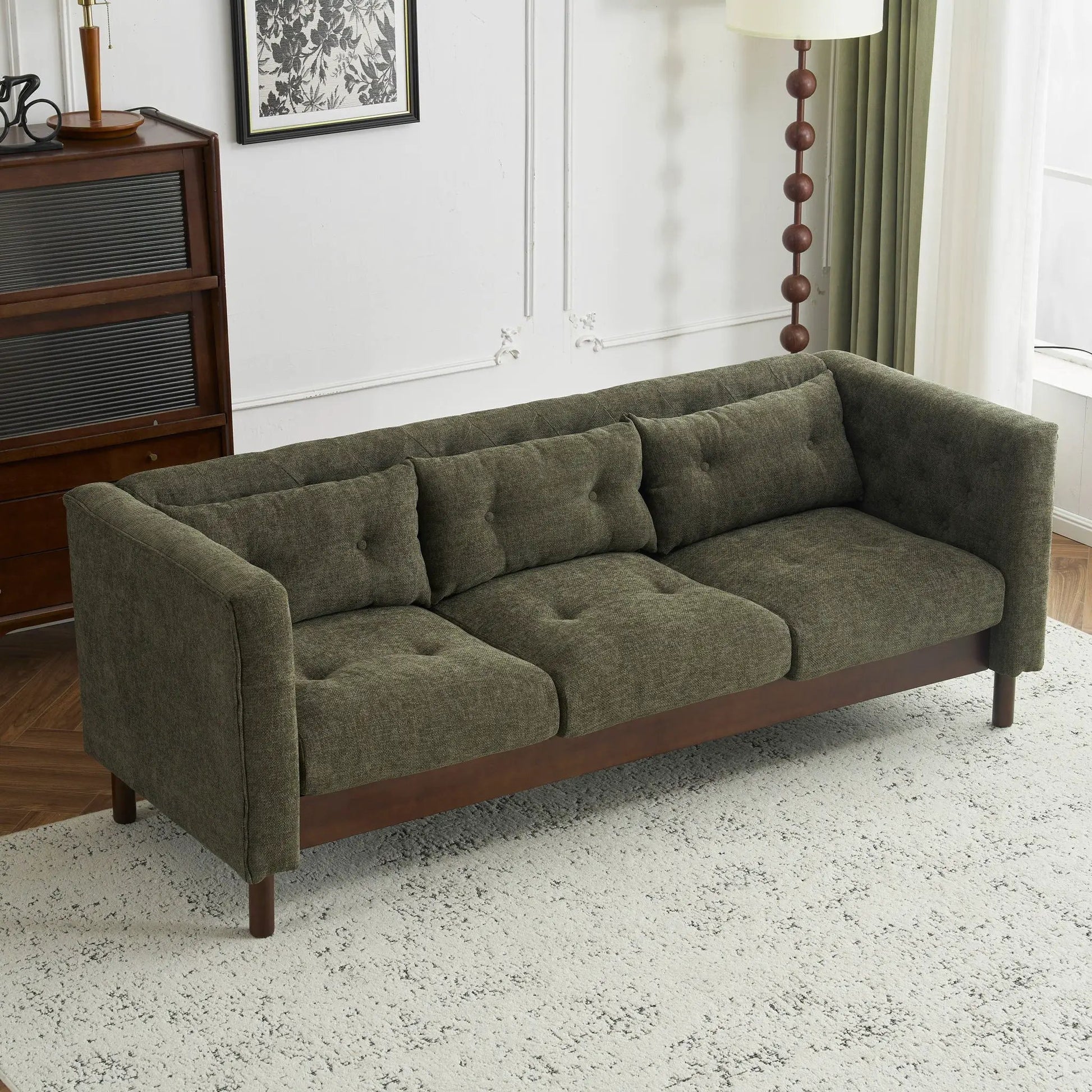 3-seat upholstered sofa in olive-gray fabric with tufted cushions and dark wood base on Tampa Home & Garden Store