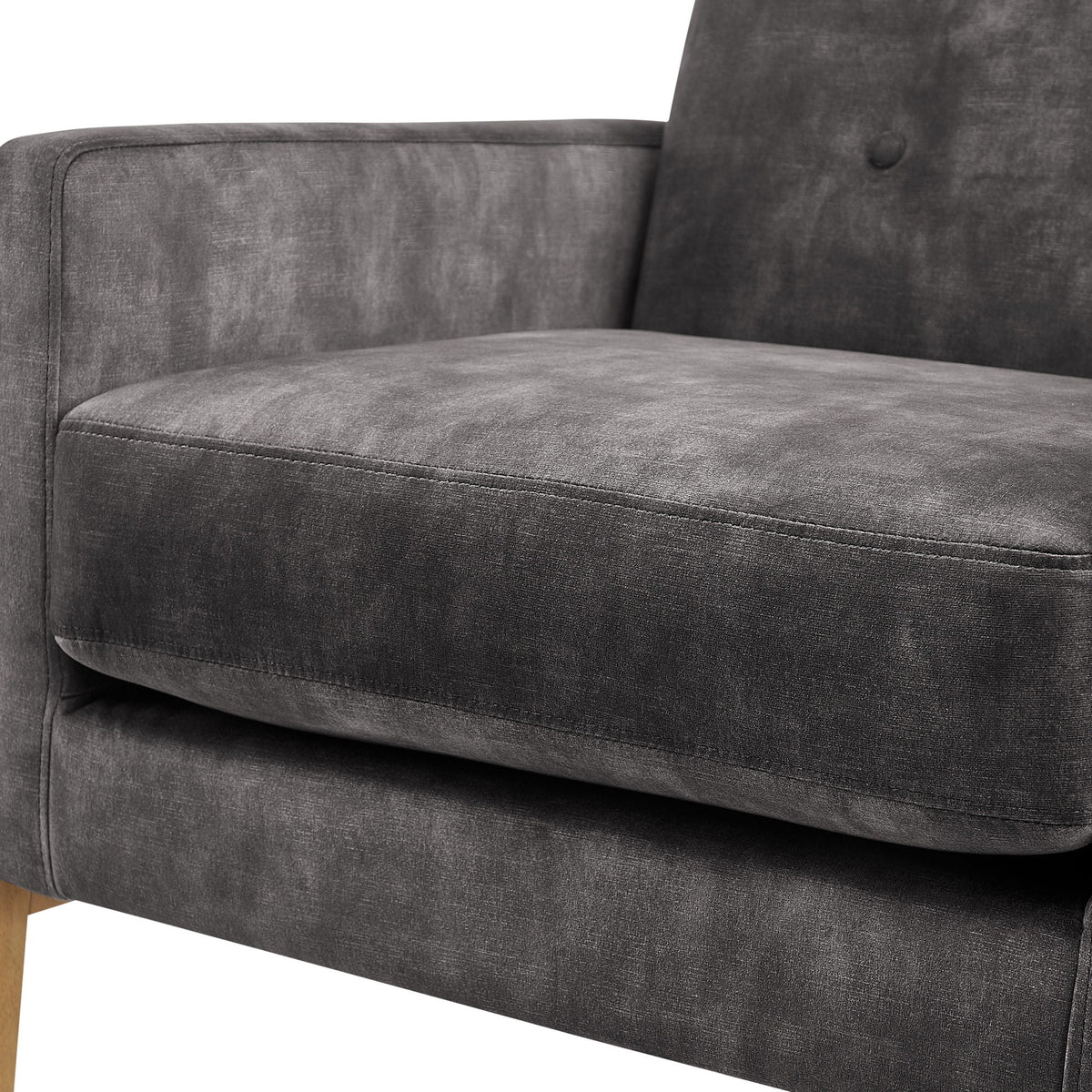 Tufted back accent arm chair in dark gray upholstery, close-up of armrest and tufted back on Tampa Home & Garden Store
