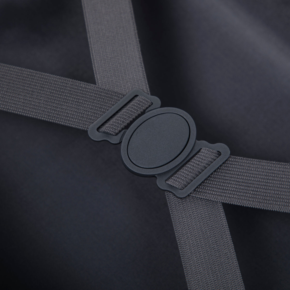 Luggage strap with plastic buckle on dark fabric; gray nylon webbing on Tampa Home & Garden Store