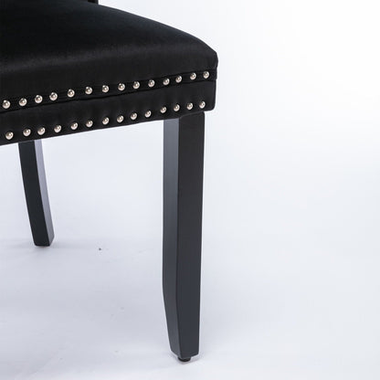 Tufted velvet dining chair set in black with silver nailhead trim, chair leg visible on Tampa Home & Garden Store
