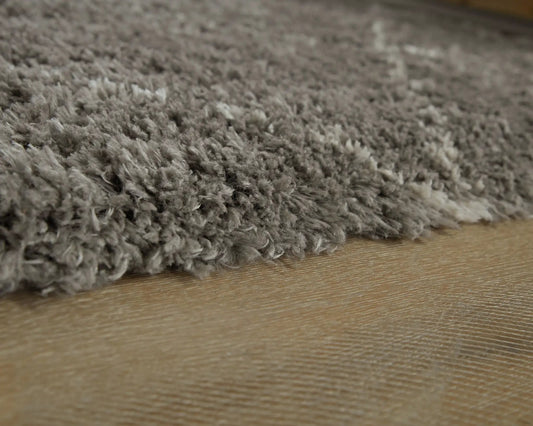 Wrenlow area rug plush gray shag fibers on wood floor by Unique Piece Furniture on Tampa Home & Garden Store