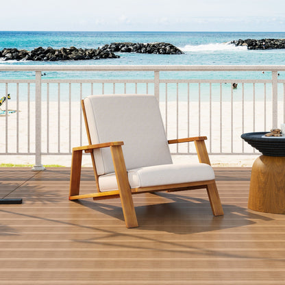 Outdoor patio lounge chair with beige fabric cushion and light wood frame on a beach deck on Tampa Home & Garden Store