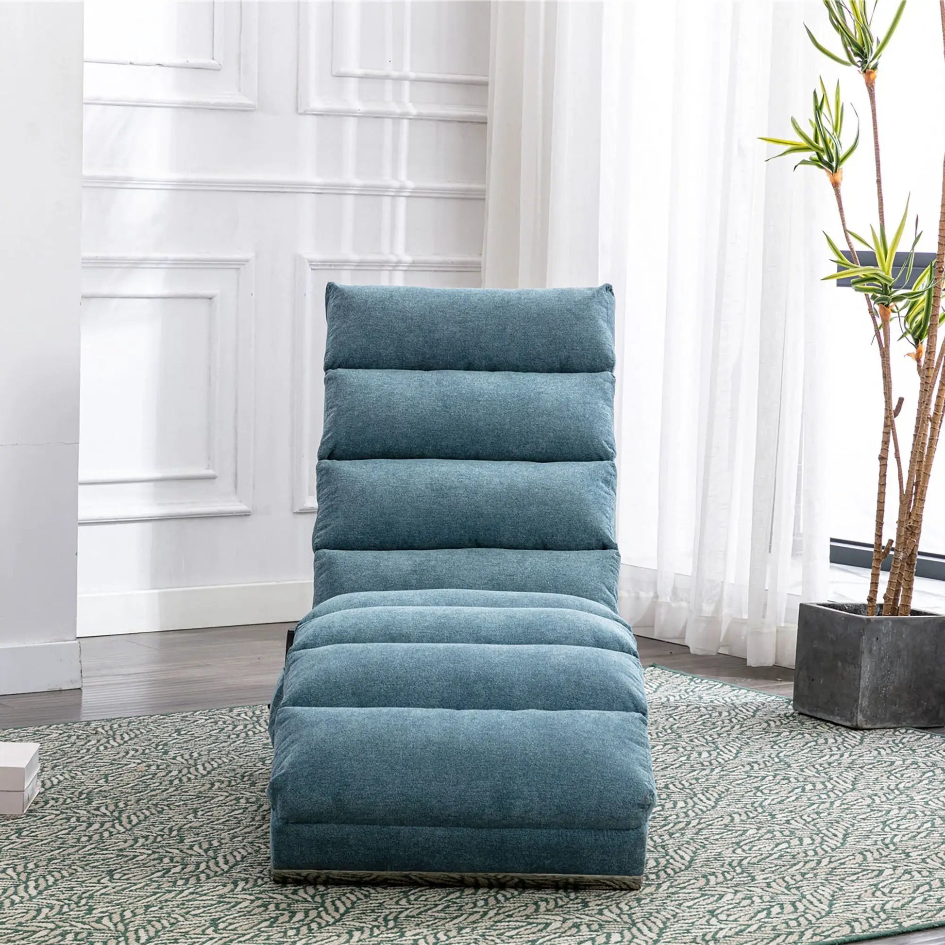 Massage chaise lounge in teal blue upholstery with segmented cushions for indoor use on Tampa Home & Garden Store