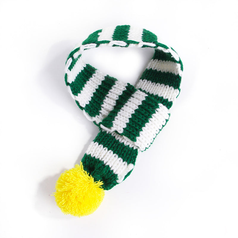 Knitted striped scarf in green and white with a bright yellow pom-pom on Tampa Home & Garden Store